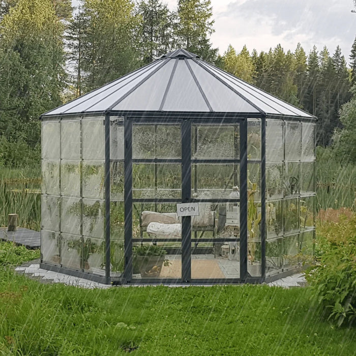12 ft Oasis hex greenhouse installed in a garden with crystal-clear wall panels and hexagonal design
