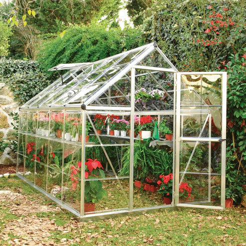 6x10 Harmony greenhouse installed outdoors in a backyard garden