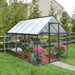 6x10 hybrid greenhouse installed outdoors in a backyard garden with plants growing inside