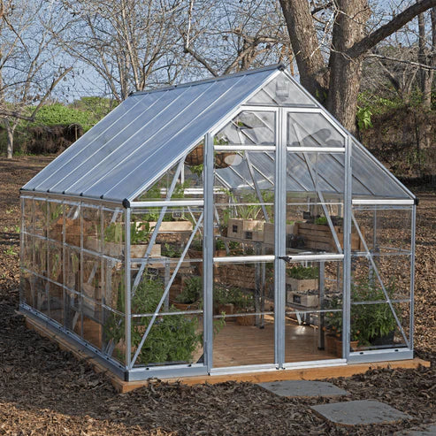Side view of 8 x 12 Balance greenhouse showing polycarbonate panels, roof vents, and double doors