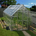 8 x 12 ft Octave greenhouse installed in a backyard garden with double doors and roof vents