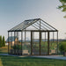 Exterior view of Aria 10 x 10 ft aluminium greenhouse in a backyard setting