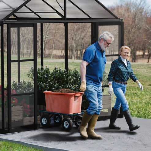 Wide double doors on Aria 10 x 10 greenhouse allowing easy wheelbarrow access
