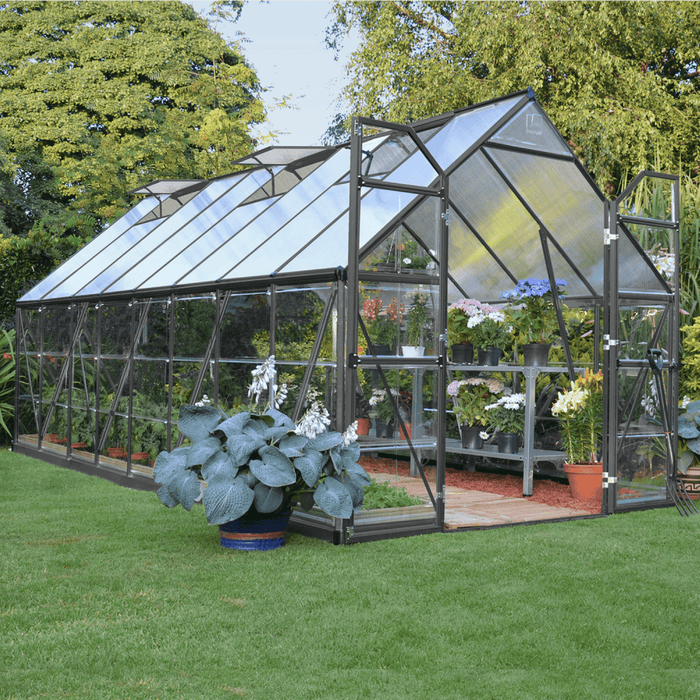 Balance 8 x 16 greenhouse installed in a backyard garden with vegetables growing inside