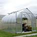 Bella 8x12 bell greenhouse installed on lawn showing curved roof and double doors