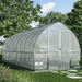 Bell-shaped Bella greenhouse with curved polycarbonate roof and wide entry doors