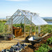 10 × 16 walk-in greenhouse set up in a backyard garden