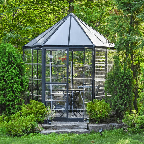 Alt Text:
hexagonal Oasis greenhouse positioned in landscaped garden area