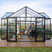 Interior of Triomphe garden chalet greenhouse showing lounge furniture and open layout