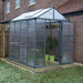 Glory 6x8 greenhouse installed in a backyard with brick wall and paved base